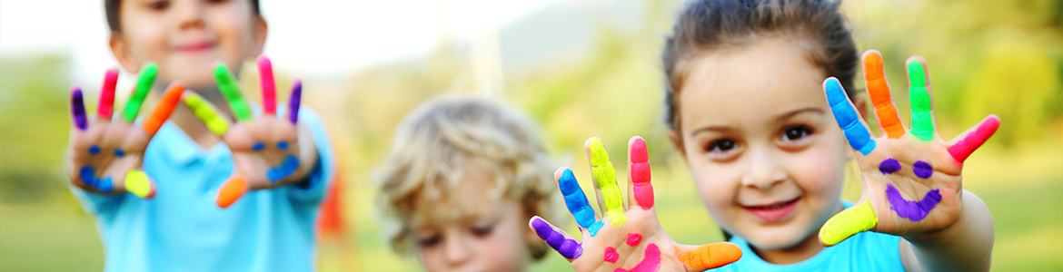 Two of the three kids in the image are showing their painted hands